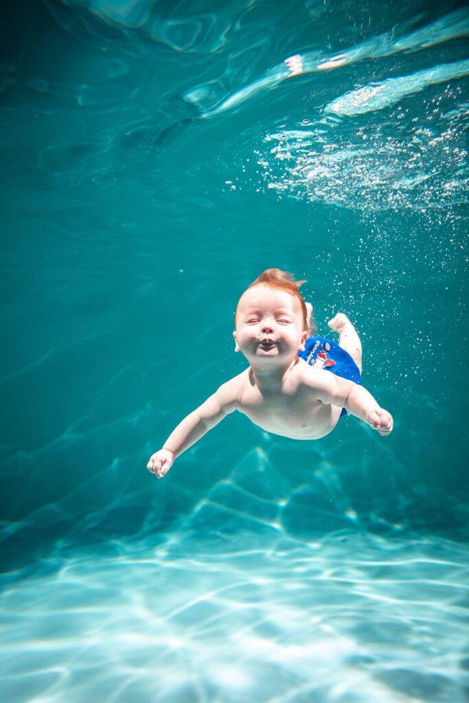 A baby is having his under water swimming session here at Cool Swim School
