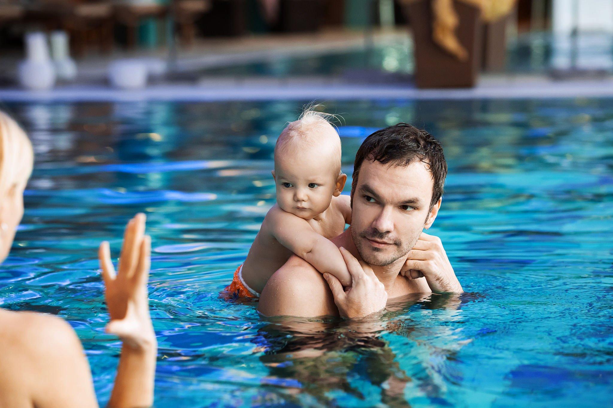 baby enjoying a spin on his dad's shoulder at the pools in North Miami Beach